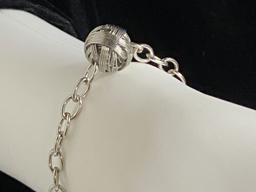 Pre-loved rhodium plated love knot bracelet