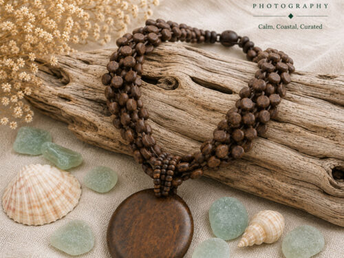 Vintage multi-strand boho bib necklace made with brown coconut shell wood beads and a large round wood pendant.