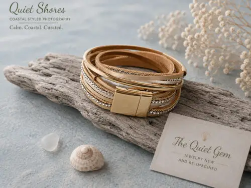 Pre-loved beige multi-layer leather wrap bracelet featuring sparkling rhinestone bands, gold tone chain accents, and a magnetic clasp displayed on a white jewelry stand.