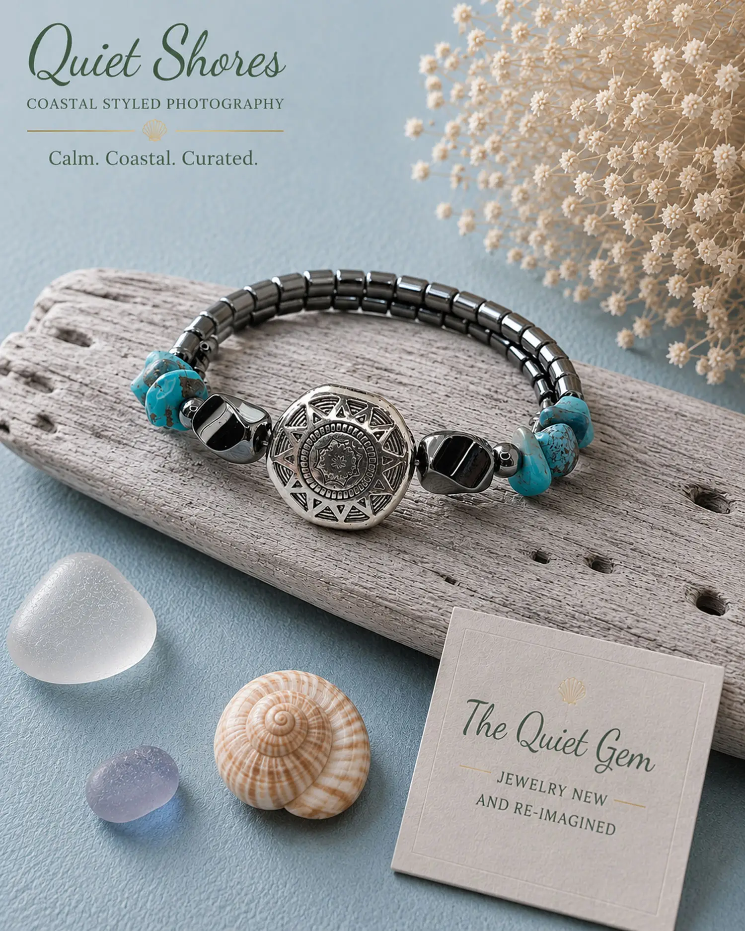 Small Southwestern style memory wire bracelet with polished hematite beads, turquoise chip beads, and a silver tone floral focal bead displayed on a white jewelry stand.