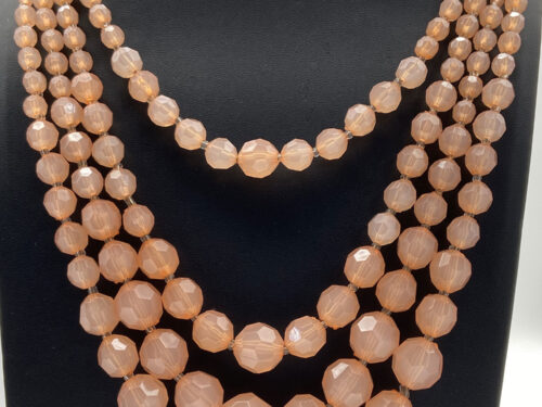 Pre-owned peach Lucite graduated multi-strand necklace with gold-tone accents and 2-inch extension