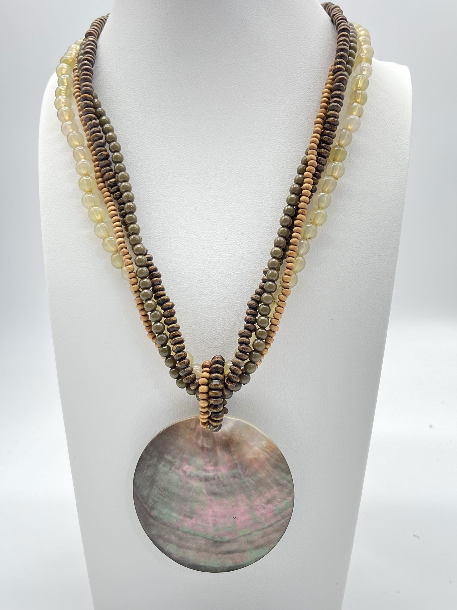 Pre-owned multi-strand wood and glass bead necklace with round iridescent mother-of-pearl pendant