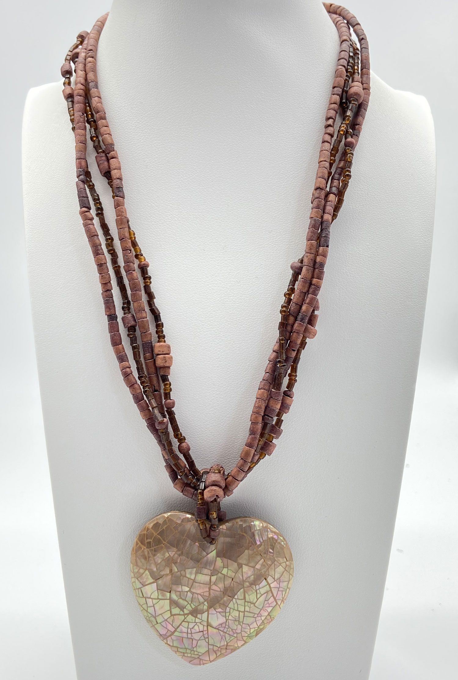 Pre-owned multi-strand wood beaded necklace with earthy brown beads and an iridescent mosaic Mother of Pearl heart pendant.