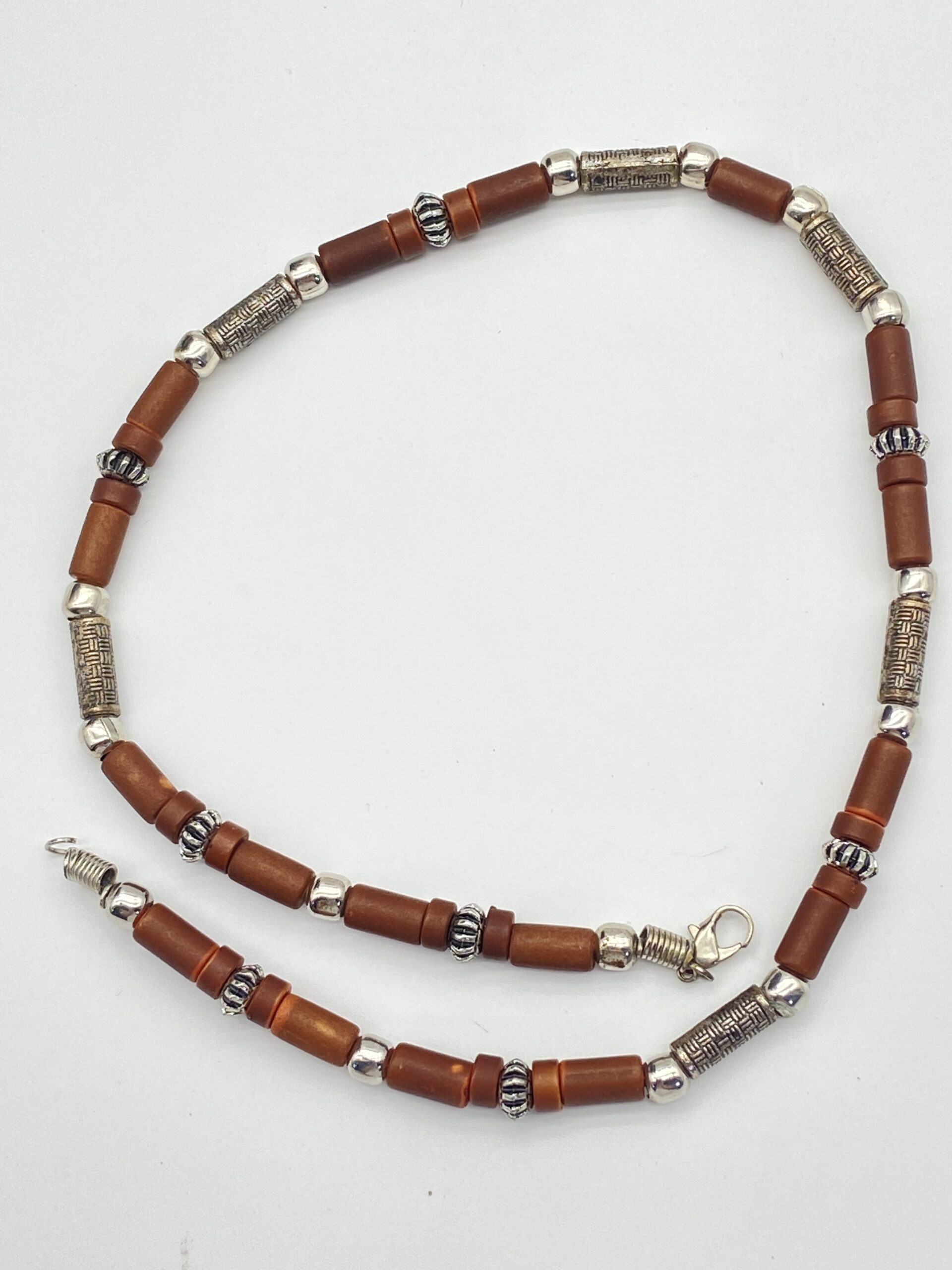 Pre-owned wood tube bead necklace with brown wooden beads and detailed silver-tone metal spacers