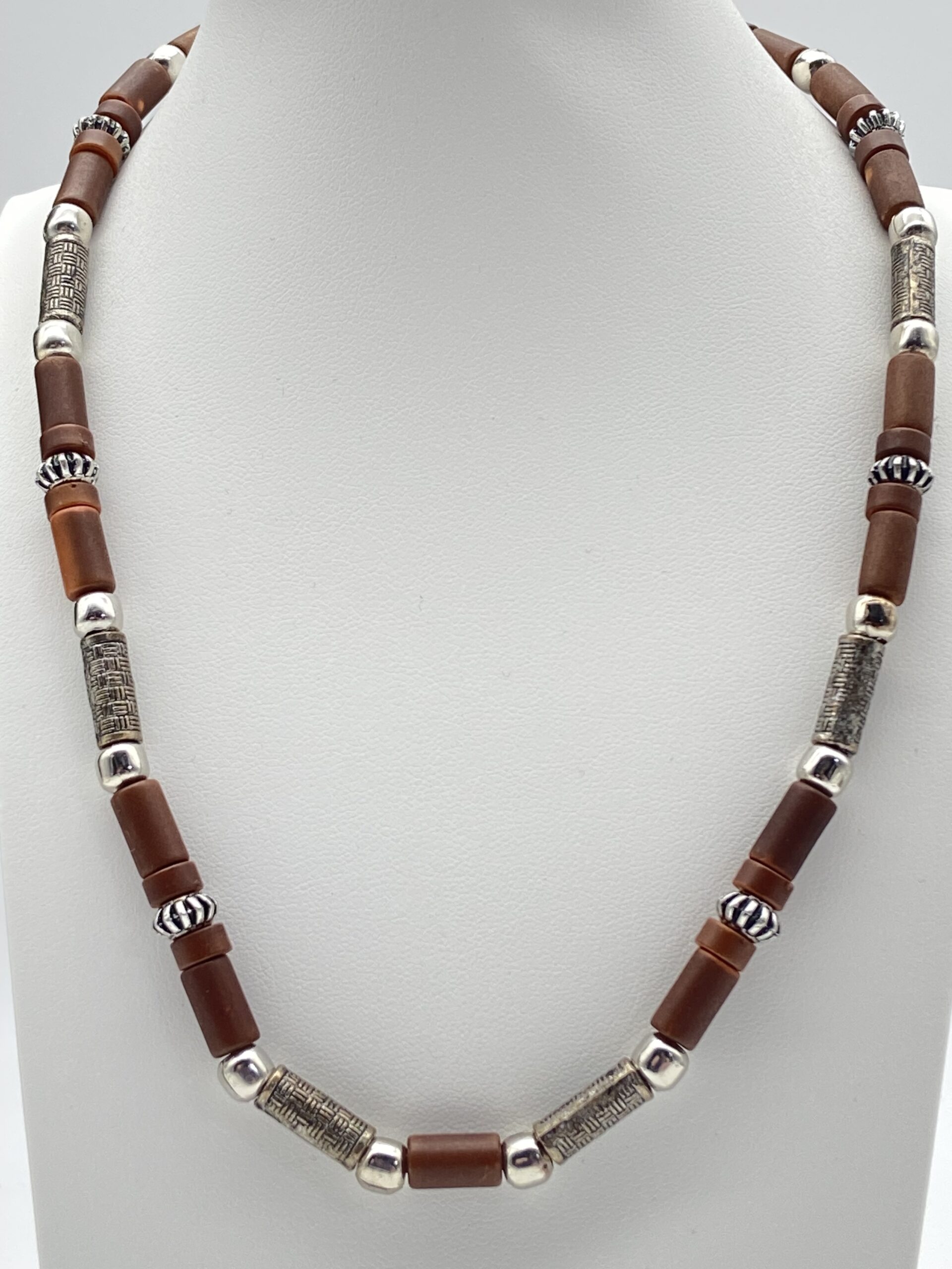 Pre-owned wood tube bead necklace with brown wooden beads and detailed silver-tone metal spacers