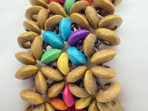 Vintage colorful wooden disk stretch bracelet with natural wood beads and vibrant rainbow-colored accents in turquoise, green, purple, pink, yellow, orange and red.
