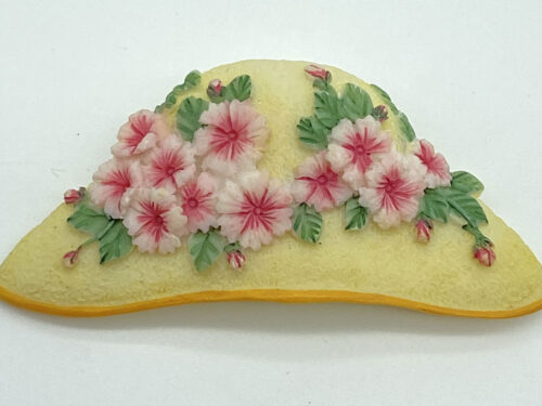 Pre-owned yellow plastic floral hat brooch with pink flowers and green leaves