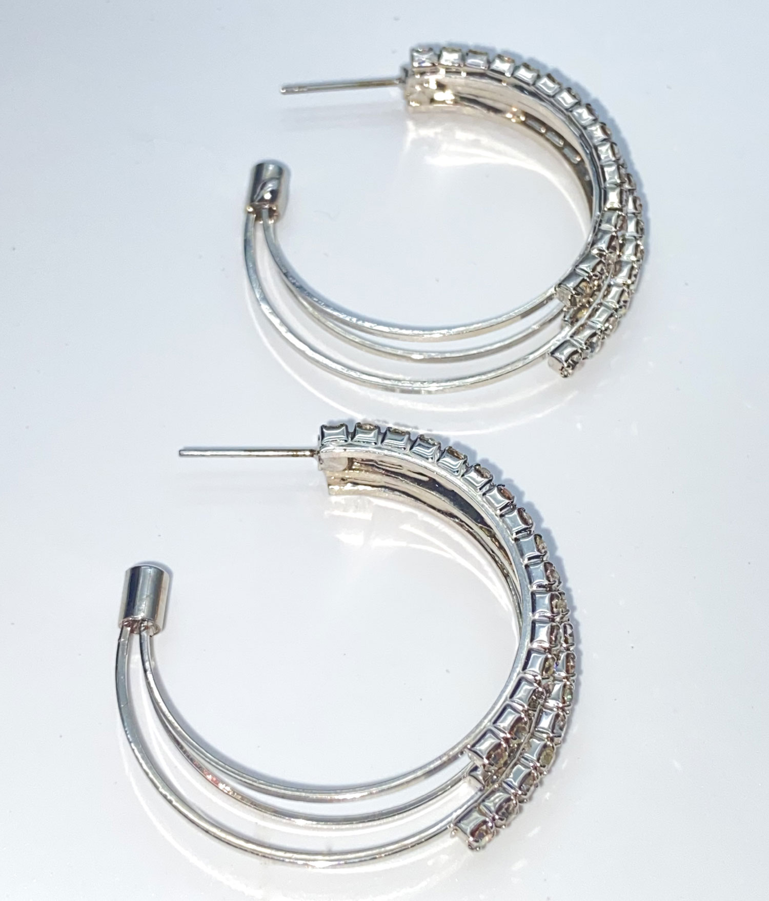 Pre-owned rhodium-plated silver-tone rhinestone half-circle post earrings with multiple sparkling drops