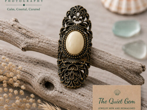 Vintage antique brass filigree ring featuring a large smooth cream-coloured oval stone surrounded by ornate openwork detailing.
