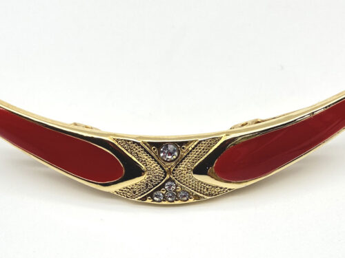 Vintage gold-tone sweater clip with bright red enamel and crystal-like accents