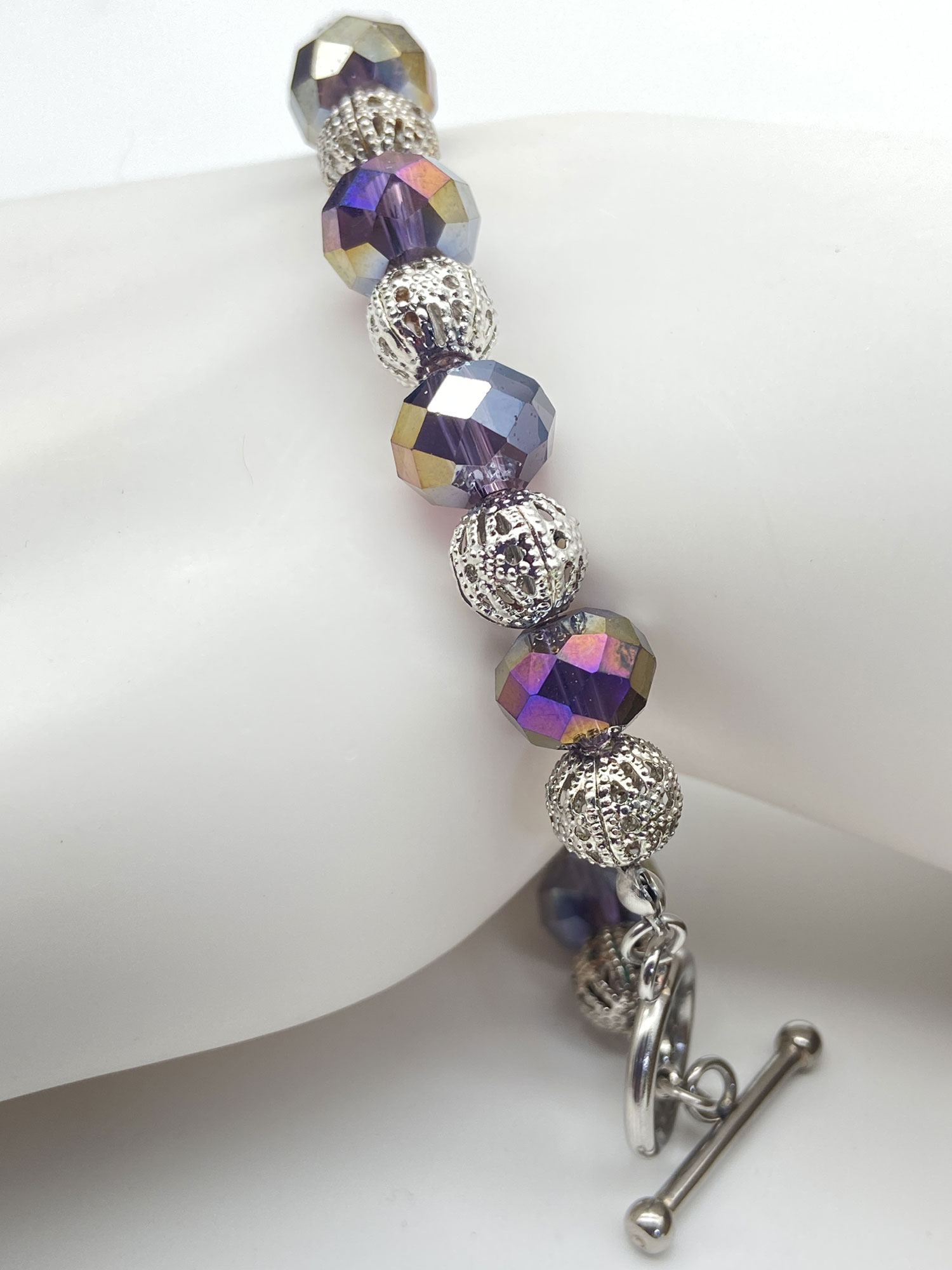 ND Reimagined purple faceted glass bead bracelet with iridescent AB accents, silver-tone filigree beads, and a toggle clasp.