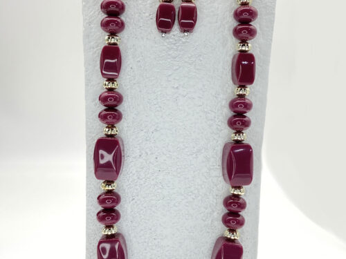Pre-owned berry-purple acrylic beaded necklace with gold-tone accents and matching drop earrings, displayed as a coordinated jewelry set.