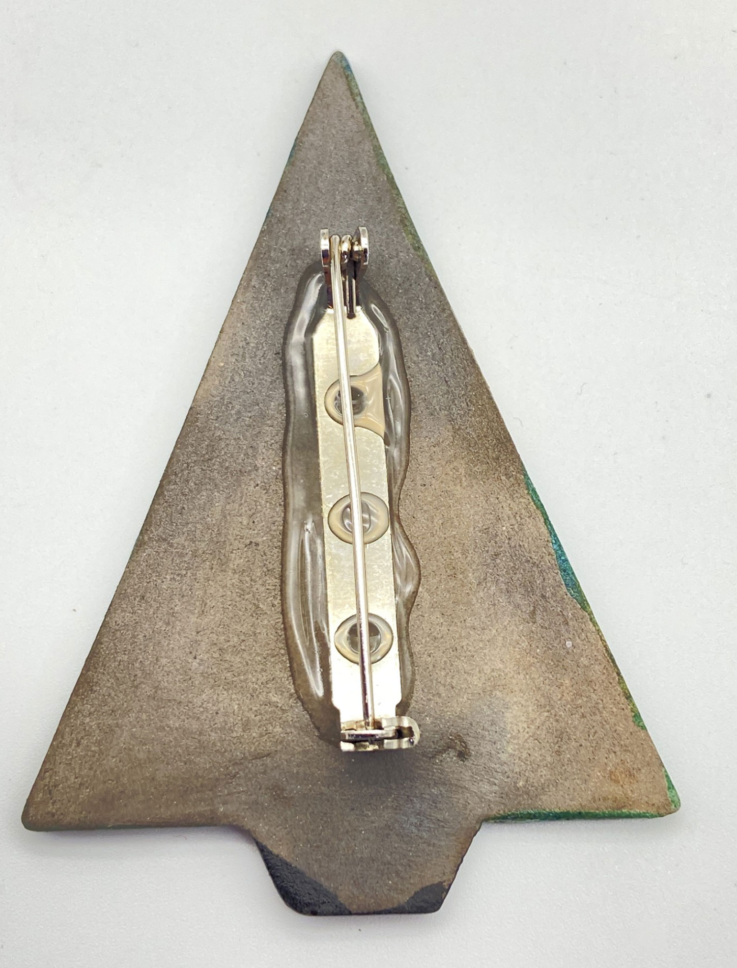 Pre-owned ceramic Christmas tree brooch with textured blue and green sections and five gold-colored circular accents-back