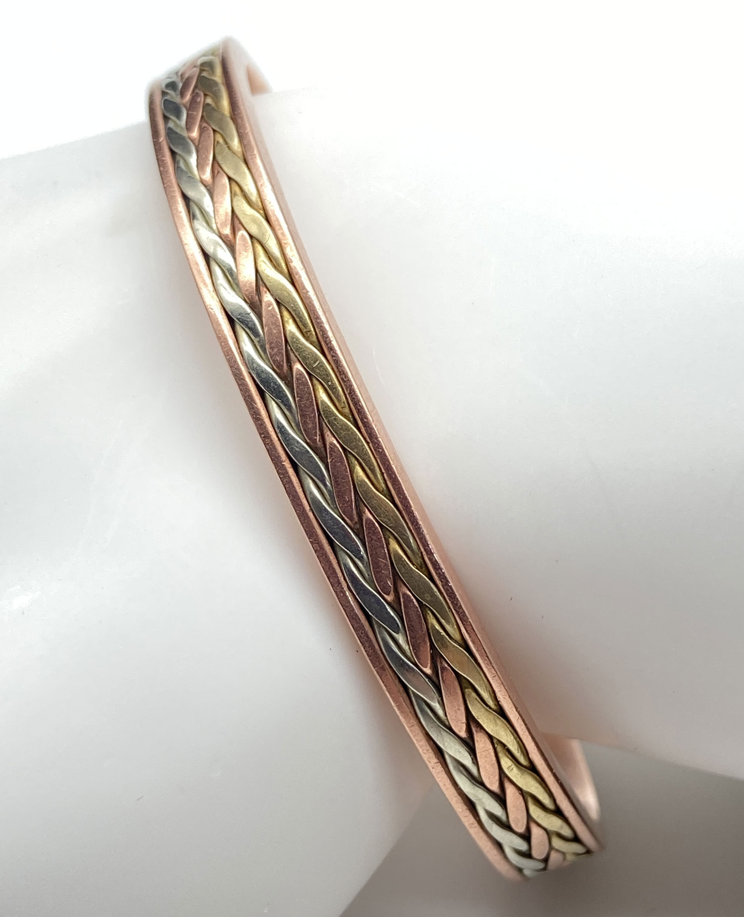 Pre-owned open cuff bracelet featuring an intertwined braided-style design in copper, brass, and silver tones.