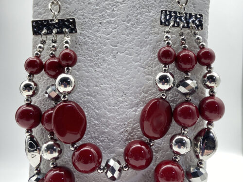 Three-strand dark red faux bead necklace with colourful Millefiori-style beads and silver-tone accents, adjustable from 16 to 23 inches.