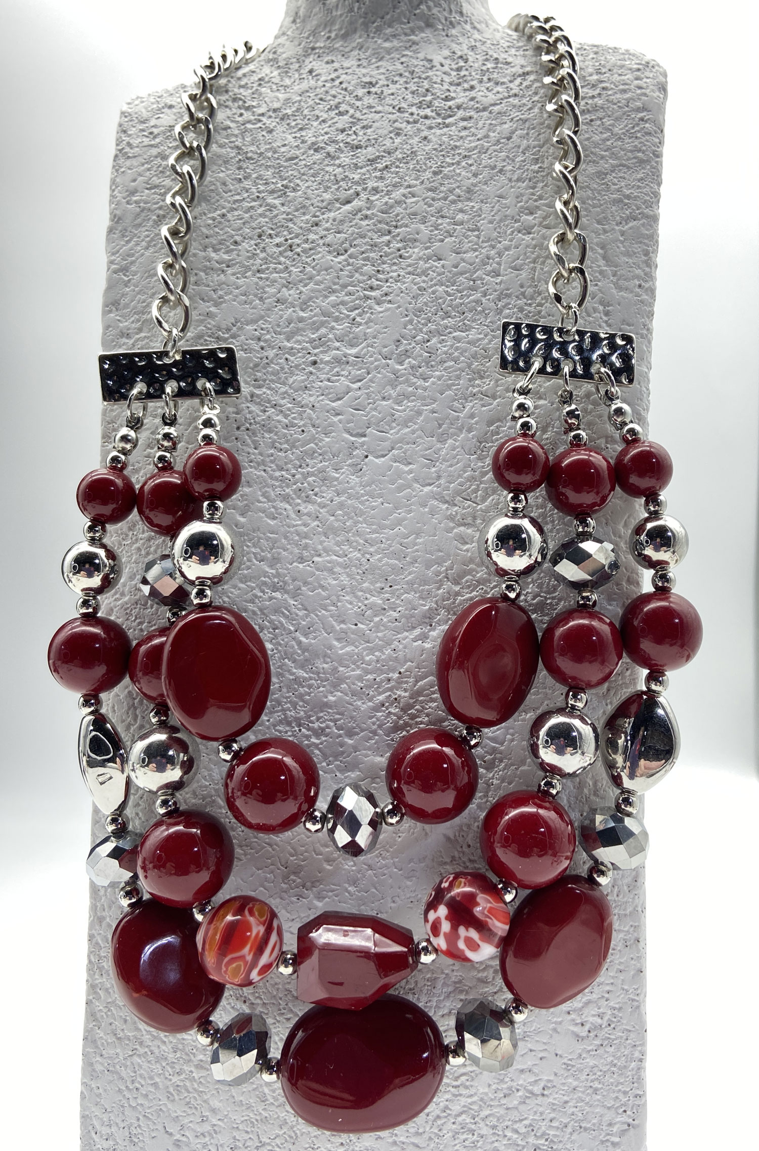 Three-strand dark red faux bead necklace with colourful Millefiori-style beads and silver-tone accents, adjustable from 16 to 23 inches.